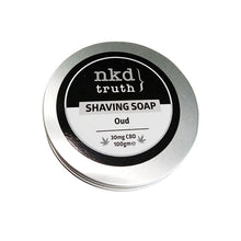 Load image into Gallery viewer, A round metallic tin featuring a black and white label on the lid. The label displays &quot;nkd truth&quot; at the top, &quot;SHAVING SOAP&quot; centrally, and &quot;Oud fragrance&quot; beneath it. At the bottom, it notes &quot;30mg CBD 100gme.&quot; This men’s grooming essential is likely NKD&#39;s 30mg CBD Speciality Shaving Soap with an Oud scent.
