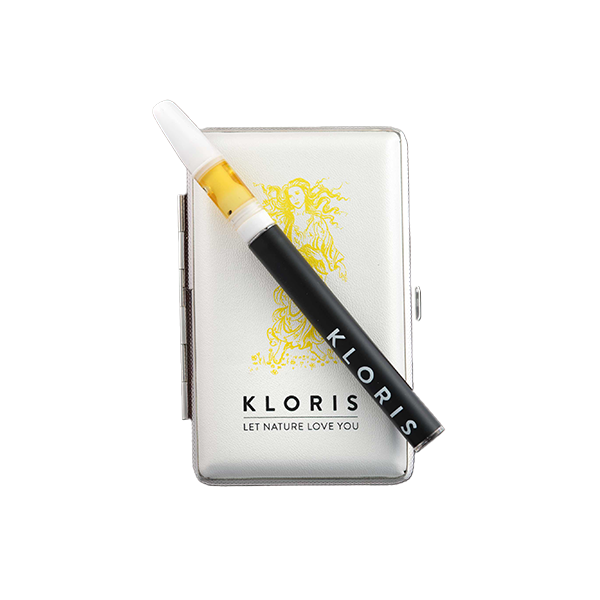 A sleek black Kloris 250mg Inhale CBD Vape Kit - 200 Puffs rests on a closed white case adorned with an intricate golden design of a person with flowing hair. The text 