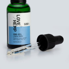 Load image into Gallery viewer, A blue and green bottle labeled &quot;Love Hemp 600mg Peppermint CBD Oil - 30ml, Premium hemp extract with organic MCT oil&quot; is shown. The label indicates a peppermint flavor and 600 mg strength. A dropper cap is placed next to the bottle, with droplets of CBD oil visible inside the dropper.
