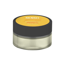 Load image into Gallery viewer, A small, round container with a black lid and transparent body, displaying a yellow label on top. The label reads &quot;Sensi Skin&quot; and &quot;CBD Infused Lip Balm Honey&quot; in white text. This vegan-friendly product contains 100mg CBD and holds 25ml of balm or cream.
