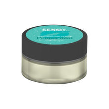 Load image into Gallery viewer, A small, clear plastic jar with a black lid features a teal label adorned with white text. The label reads &quot;Sensi Skin,&quot; followed by &quot;Peppermint,&quot; &quot;shea infused sugar lip scrub,&quot; and &quot;100mg CBD.&quot; The vegan-friendly Sensi Skin 100mg CBD Sugar Lip Scrub - 25g (BUY 1 GET 1 FREE) contains a light-colored substance inside.
